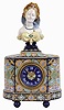 France, faience mantel clock, the earthenware case with ball feet, central square section flanked by round ends, and mounted with a female bust, all decorated in brightly colored polychrome tin glazes, and signed by the maker, Roman numeral faience dial with fancy gilt hands, 8 days, time and strike pendule a Paris movement marked Japy Freres, c1890