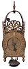 England, unsigned lantern clock, the brass case with turned columns, finials, and feet, top with pierced frets, the front fret with engraving, Roman numeral brass dial, pierced steel hand, 30 hour, weight driven time and strike bob pendulum movement with crown wheel escapement.