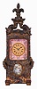 France, hour repeating carriage clock in the form of a sedan chair, the gilt and silvered brass case with faux repousse rococo style ornament, case sides with well executed portraits of a young woman within pink guilloche and polychrome enamel frames, the top with scrolled brackets supporting a fleur de lis finial, Roman numeral gilt metal dial, also with pink guilloche and polychrome enamel surround, the dial above a small, painted garden scene, blued steel hands, 8 day, time and strike movement with lever platform, counting the hours on a gong, and repeating the last hour on demand