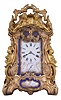 Attributed to Drocourt, Paris, a rare and extremely decorative giant carriage clock in the rococo style, the gilt case replete with scrolls, foliate ornament, and putti, and set with eight gilt and polychrome enamel porcelain plaques featuring garden scenes and frolicking amorini, each on a deep blue field with gilt, foliate border, the Roman numeral dial with blued steel hands, case back with sliding glass panel to allow access for winding and setting, 8 day time, strike, and alarm movement with lever platform, repeating the last hour on demand, gong base marked 