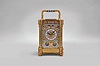 France, an unusual, champleve enamel decorated, pillars style hour repeating carriage clock, the gilt case with outset corners, turned feet and columns, the base, frieze, and top with scrolling foliate designs, and decorated with polychrome enamel colors on a turquoise ground, the front of base with engraved presentation 