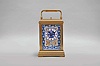 France, attributed to Gaye, Lamaille, & Co., a fine, Aesthetic Movement, porcelain paneled hour repeating carriage clock, the gilt, Cannelee variant case with folding handle, the sides set with panels depicting a potted flower in blue, on a cream ground, also with floral ornament, and with blue, wheatear border, the Arabic numeral dial with ornament matching the side panels, blued steel spade and whip hands, two train, 8 day movement with lever platform, striking the hour and half hour in passing, and repeating the last hour on demand, the back plate marked 