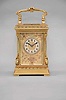 France, a highly ornamental and well executed hour repeating carriage clock, the gilt, Anglaise Riche variant case with stepped base below a fluted band and egg and dart molded surface canted corners ornamented with acanthus scroll bases and E scroll tops, supporting an entablature echoing the base, with fluted band, stepped cornice, and egg and dart cap, the top with folding handle decorated with acanthus and central scallop shell, all decorative ornament with fine chasing, Arabic numeral silvered dial with blued steel distaff hands, and gilt mat with applied, gilt floral ornaments, also finely chased, 8 day, two train movement with lever platform and cut bimetallic balance, striking the hour and half hour in passing, and repeating the last hour on demand