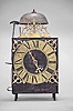 France, Comtoise lantern clock, 30 hour, time and strike, weight driven movement with rare Maillet or Mayet escapement and atypical vertical rack strike with side mounted hammers, iron post and plate frame construction, brass dial with engraved Roman numerals, single brass hand, brass spandrels above and pivoted winding arbor shutters below, all topped with a pierced brass fronton with fleur de lis at the apex.