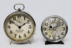 Two desk-top alarm clocks.