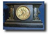 E. Ingraham Black Wood clock with marbleized columns, circa 1900's