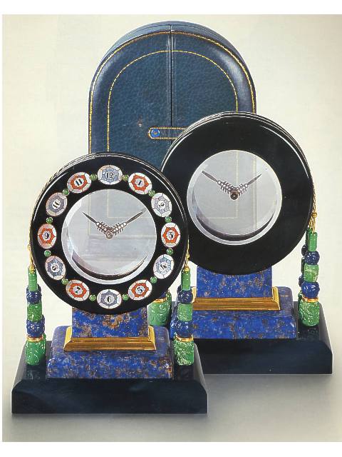 Mystery clock, whose form and decoration are inspired by the Aztec Sun Stone, in original leather fitted box. Black, Starr & Frost, New York, made by Rubel Freres, Paris, circa 1920. — Antique Clocks Price Guide