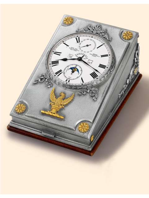 Exceptional, one of only two known, astronomical double barrel, eight day going large silver desk clock with perpetual calendar, phases of the moon and eight day power reserve indicator, accompanied by two original silver/gold/steel keys and matching calendar adjustment pin. Patek Philippe & Cie., Geneve, made in 1927. — Antique Clocks Price Guide