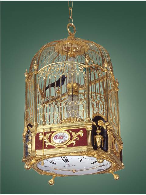 Gilt brass and enamel, two singing bird hanging cage with a center-seconds clock beneath, 12-stream fountain, playing four tunes on demand or changing automatically on the hour. Attributed to Jaquet-Droz, Geneva, circa 1780. — Antique Clocks Price Guide