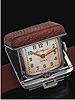 Timex, "Ben Hogan". Produced in the 1970's. Stainless steel and sharkskin clip wristwatch with concealed dial, removable from the wrist or the belt to become a little bedside table clock.