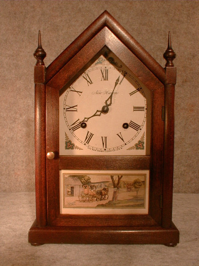 "VERMONT" STEEPLE CLOCK BY THE NEW HAVEN CLOCK CO. THE CASE IS SOFTWOOD IN A DARK FINISH. CIRCA 1930'S. — Antique Clocks Price Guide