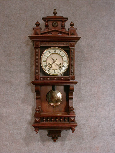 THIS IS A GERMAN DWARF BERLINER STYLE WALL CLOCK WITH A BOTTOM GALLERY. CIRCA 1900. — Antique Clocks Price Guide