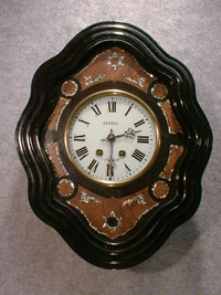 THIS IS A DWARF FRENCH PICTURE FRAME WALL CLOCK IN A SQUIGGLE FRAME. CIRCA 1900. — Antique Clocks Price Guide