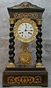 FRENCH EMPIRE CLOCK IN A WALNUT AND EBONY CASE, CIRCA 1840.