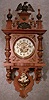 GERMAN BERLINER BY THE MAUTHE CLOCK CO., TRADEMARK FMS. WALNUT AND LINDENWOOD CASE. CIRCA 1895-1910.