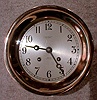 THIS IS A HINGED CASE 6" STRIKING SHIP'S BELL CLOCK IN A RED BRASS CASE. CIRCA 1954.