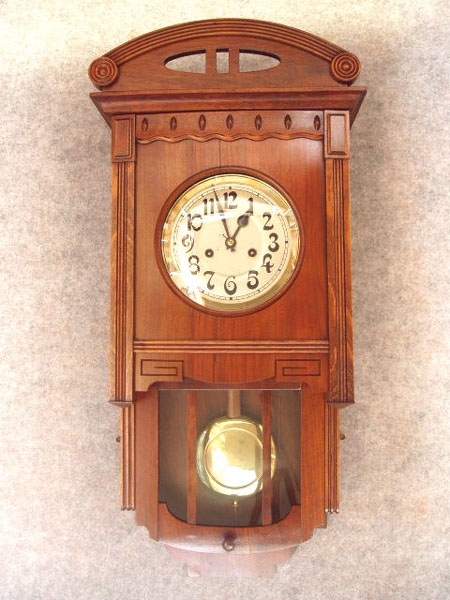 German "Berliner" Style Wall Clock With An Encased Bottom And Original Top Piece In A Walnut Veneered Art Deco Style Case, By The Hamburg American Clock Co. Circa 1910-1920. — Antique Clocks Price Guide