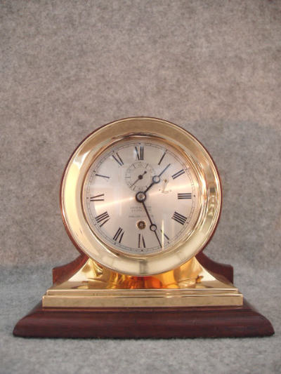 Chelsea Clock Co. 4 1/2" Red Brass Case And Base Attached To A Mahogany Stand, Serial No. 37977, Circa 1907. — Antique Clocks Price Guide