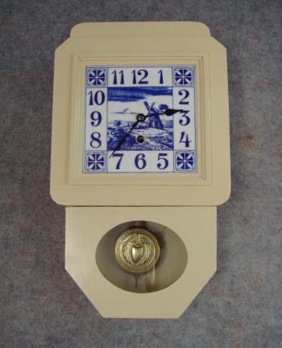 This Is Junghans Kitchen Wall Timepiece "Delft", In A Painted Ivory Case With A Dutch Scene Tile Dial. Circa 1910-1920. — Antique Clocks Price Guide