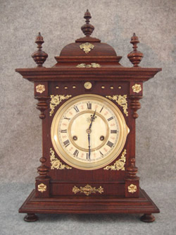 German Bracket Clock By Junghans In A Walnut Veneered And Lindenwood Solids Softwood Case, With Brass Decorations Applied And 3 Finials On Top. Circa 1900-1910. — Antique Clocks Price Guide