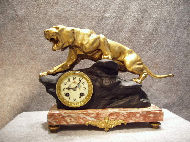 French Art Deco Style Mantel Clock With A Rose Colored Marble Base That Has An Ormolu Decoration On The Front Of The Base, A Black Spelter Rock (Signed T. Cartier) With A Gilt Jaguar On Top. Circa 1920-1930. — Antique Clocks Price Guide