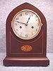 German Lancet Top Mantel Clock With Inlay And Satin Banding In A Mahogany Veneered Case, By Badische Urhenfabrik, Furtwangen, Germany.  Circa 1910-1920.