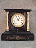 Black Enamel Cast Iron Mantel Clock By Nicholas Muller And Sons, N.Y., New York. Circa 1880-1890.
