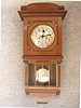 German Enclosed Bottom "Berliner" Style Wall Clock By Gustav Becker In A Walnut Veneered Case With A Matching Crown. Circa 1910-1920.
