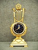 French Lyre Clock In A Gold Plated Cast Brass And White Marble Case, Circa 1890-1900.