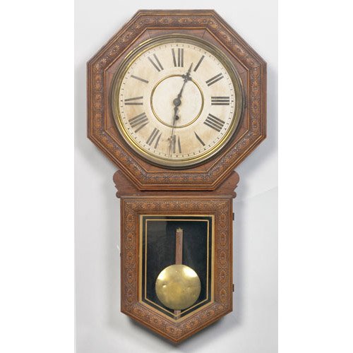 Welch Star Pointer Regulator Wall Clock pressed oak octagonal case in original varnish finish with long drop and gilt edged tablet; printed paper dial with Roman numerals marked Made by E.M. Welsh MFG. Co. Forestville Conn. U.S.A. with printed paper label on rear with model name; 17.5" wide x 4" deep x 32.5" long.From the Estate of John Auraden of Hamilton & Fairhaven, — Antique Clocks Price Guide