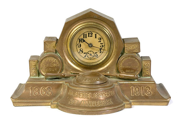 Bronzed Desk Novelty Clock Commemorating 50th Anniversary of Speidel Grocery Co., — Antique Clocks Price Guide