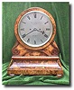 A walnut drum head bracket clock made in 1859 by Barraud and Lund of London.