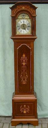 A small Edwardian longcase clock with a mahogany case inlaid with fruitwoods and boxwood. — Antique Clocks Price Guide