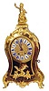 Ommolu-mounted Boule and tortoiseshell clock, the waisted case with a seated boy on top and an eagle at the bottom.