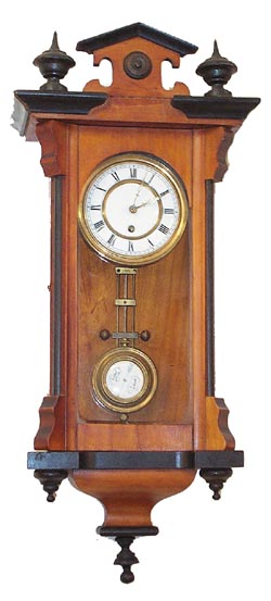 German miniature RA, 15 inch walnut case designed like the big ones, finials top and bottom, black trim around the edges and finials, 3 glasses, 2 piece porcelain dial, porcelain beat scale, porcelain RA pendulum. — Antique Clocks Price Guide