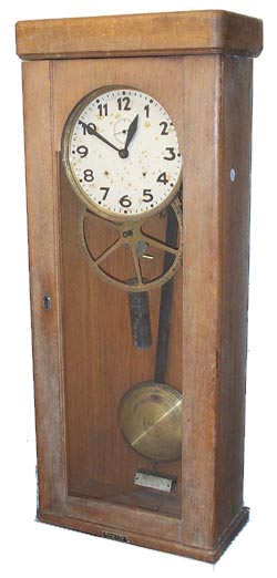 Electric clock in an oak case 35 inches high. — Antique Clocks Price Guide