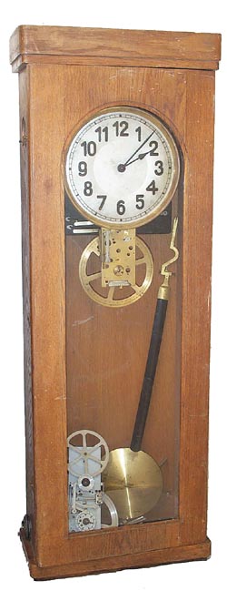 Electric clock in an oak case 39-1/2 inches high. — Antique Clocks Price Guide