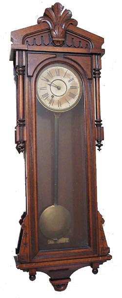 Ansonia Clock Co. hanging clock, "Bagdad", ca 1904. Oak case, 50-1/2 inches high, glass sides. — Antique Clocks Price Guide