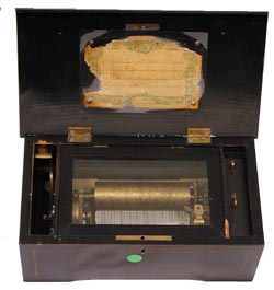 Swiss Music Box plays four tunes and has the original tune card on the lid. — Antique Clocks Price Guide