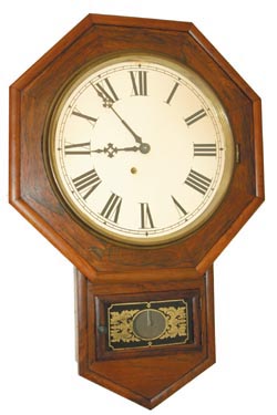 Label reads, "Barnes Bros. Clock Co." Octagon top, short drop case made of rosewood and standing 25.5" high. — Antique Clocks Price Guide