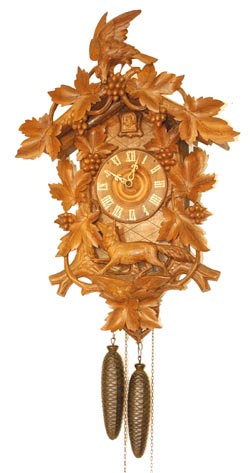 German cuckoo, large refinished case at 24" high, carved all over are leaves, nuts, a fox and a bird on top. — Antique Clocks Price Guide