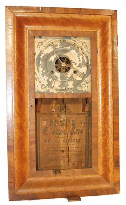 Wm. L. Gilbert 30 hour OG, brass movement, weight driven. 26" high mixed wood case, possibly rosewood on the door and outside of case, and a veneer on the curve that is unfamiliar to me but is very attractive. — Antique Clocks Price Guide