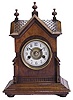 Hamburg American walnut bracket clock in a fancy little case with shingled roof and a gable in front like a German or Swiss chalet.