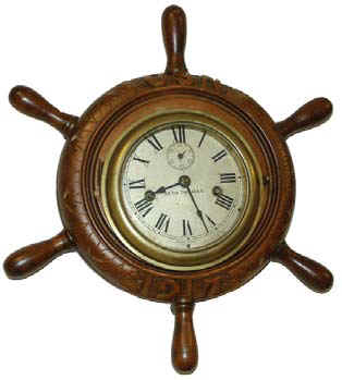 Seth Thomas Engine Lever type movement mounted into a carved ships wheel. Large letters, "U S N" carved at the top, and "1917" at the bottom. — Antique Clocks Price Guide