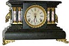 Seth Thomas wood case with adamantine finish, gilt metal trimmings and very special assorted designs on the adamantine columns.
