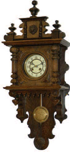 German open swinger in a 35 inches high dark oak case. The case is made so that the entire board below the movement is removable. — Antique Clocks Price Guide