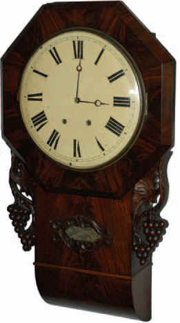 Winterhalter and Hofmeier 8 day movement in an English roll bottom short drop case. 29 inch flame mahogany case with large carved wings on the sides and carving around the lower glass. — Antique Clocks Price Guide