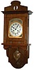 Junghans open swinger clock in a mission style walnut veneered case that is 33.5 inches high, and 14 inches wide.