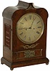 English double fusee bracket clock. Stylish mahogany veneer case is 18 inches high with brass ornaments on the front, brass ball feet, brass side windows (red cloth backing), and key locking brass bezel.
