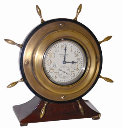 Waltham Watch Co. chronometer. It is displayed in a wood case, ships wheel motif, about 7" tall and 7" wide, brass wheel spokes all intact, and is enclosed in a brass clock case. — Antique Clocks Price Guide